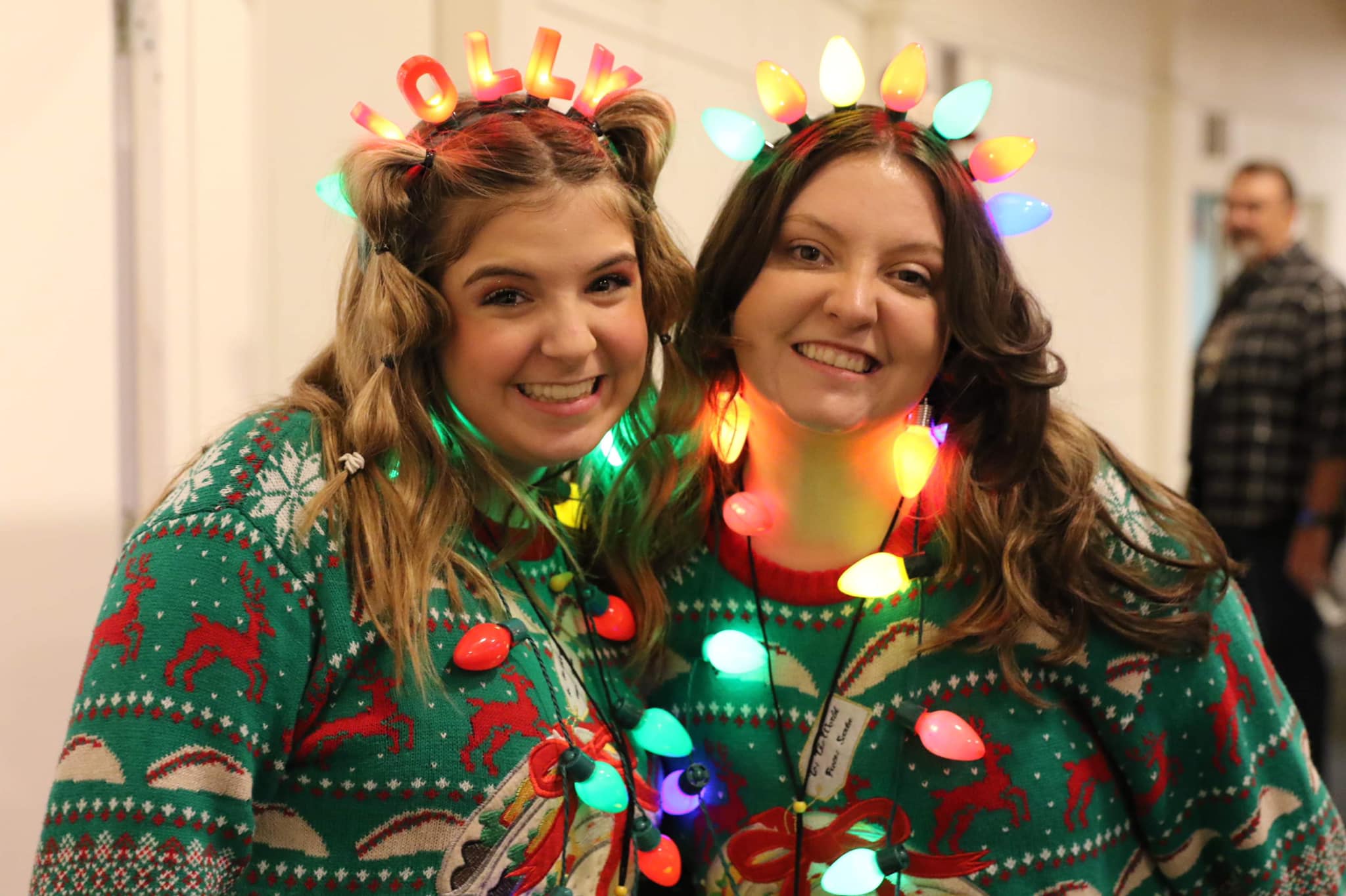 Leaders dressed in festive Christmas outfits. This image serves as the header image for our blog, 25 Christmas Ideas for Your Family Ministry