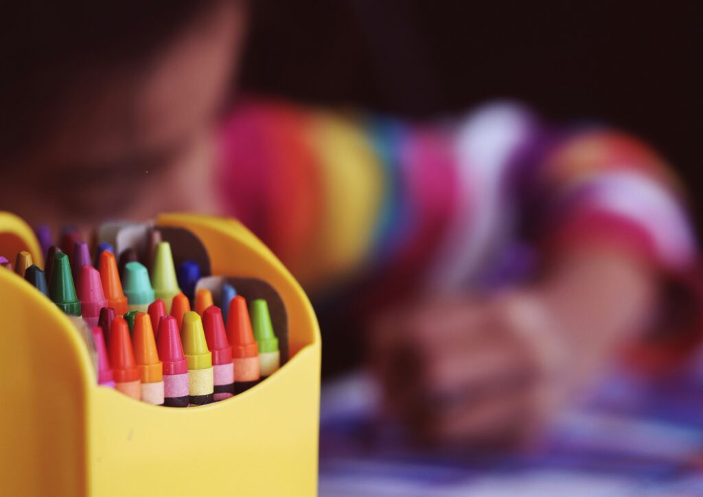 Image is of a crayon box that is used as the header image for the blog Why VBS is Important for Summer Programming