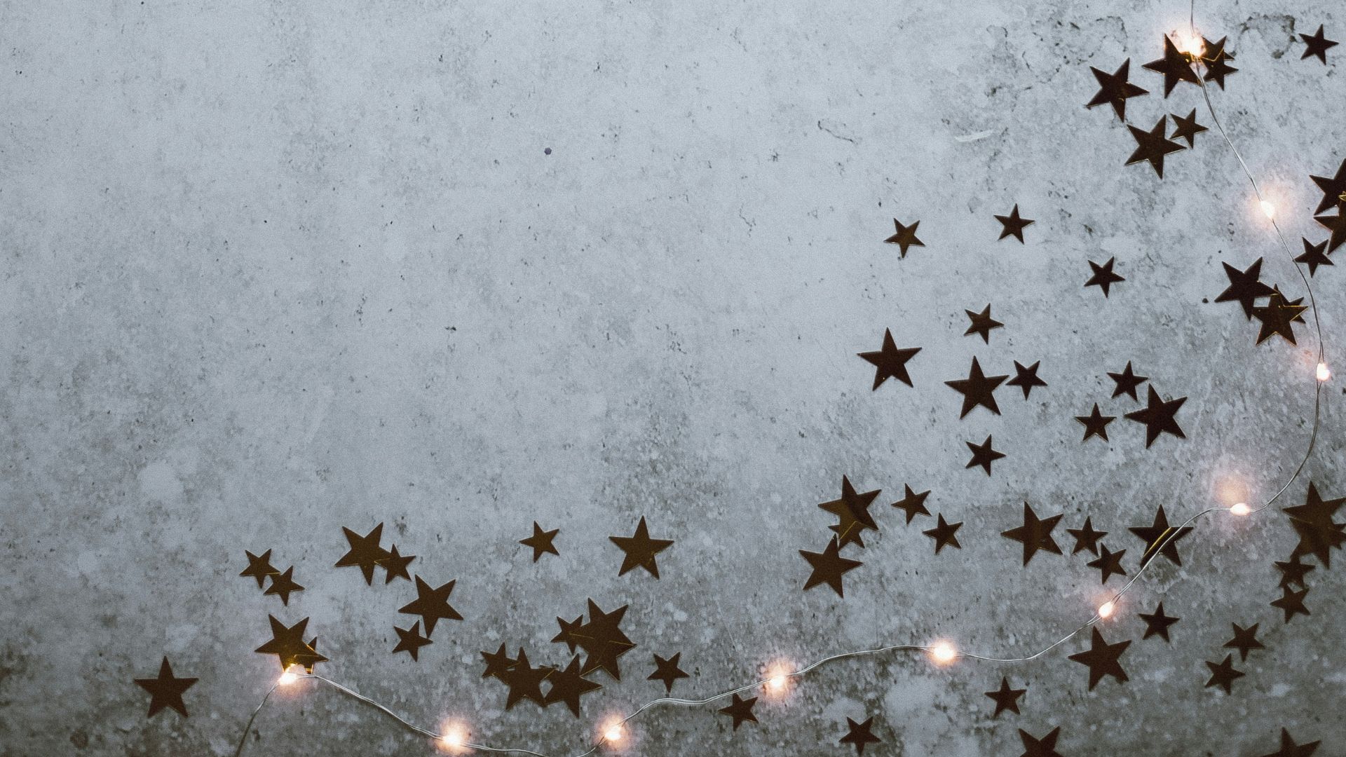 Star confetti and Christmase lights. This image is used for the 5 Do’s and Don’ts for Church Communications During the Holidays blog.