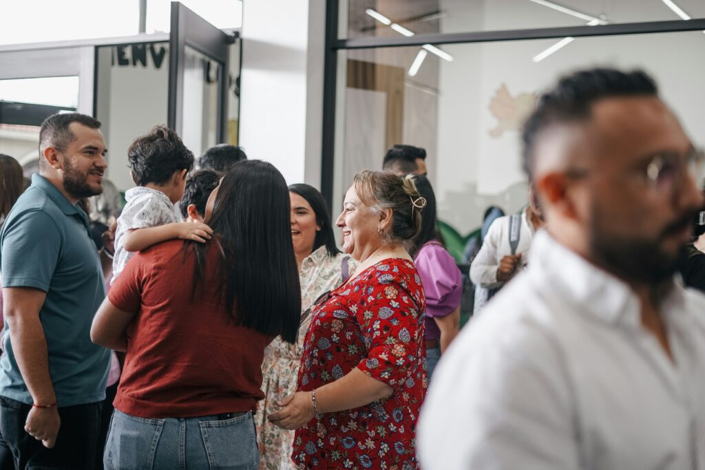 A family in a lobby of a church. This photo is being used as the header for the blog How to Welcome New Families into Your Ministry on Easter Sunday.
