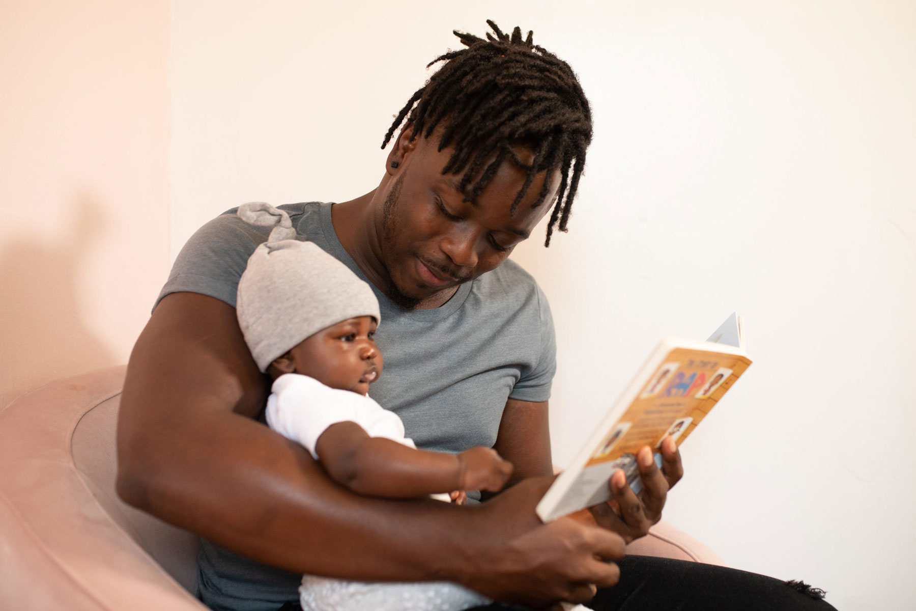 Dad Reading with New Baby
